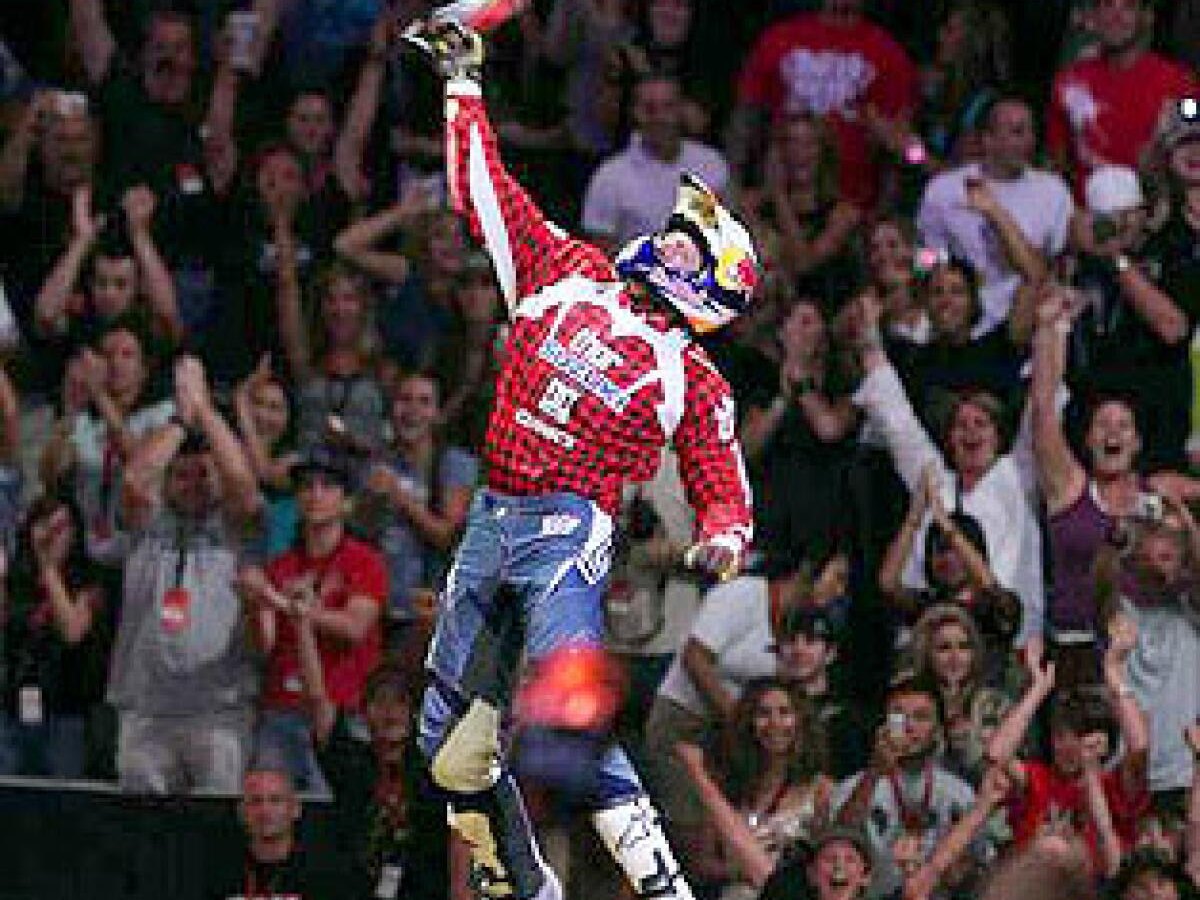A Moto X rider celebrates in front of a roaring X Games crowd